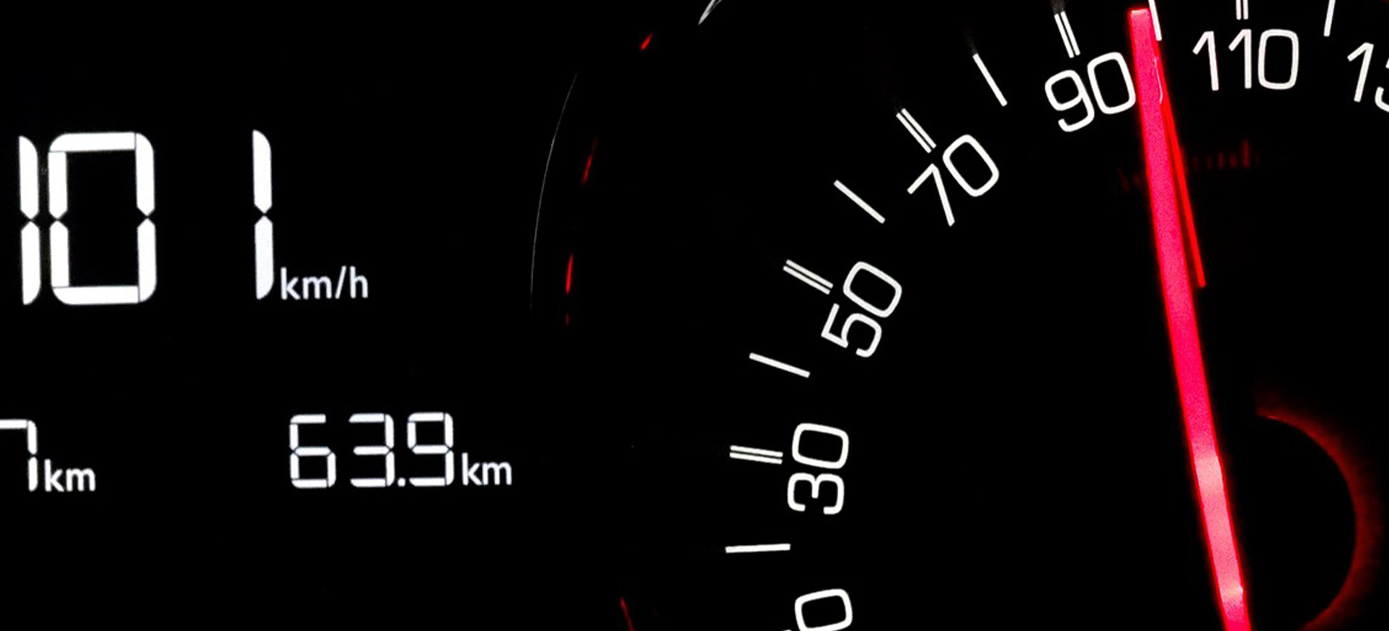 A speedometer showing a high speed as a vehicle drives